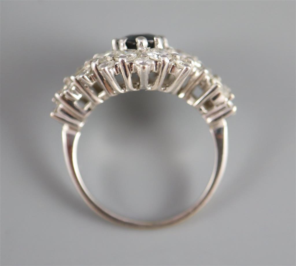 A modern 18ct white gold, sapphire and diamond cluster dress ring, with diamond set shoulders,